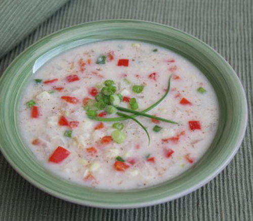 Creamy corn chowder with fancy green onion garnish.